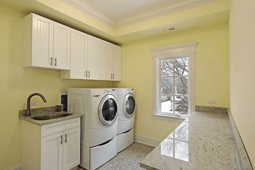 laundry space with built-in storage and sink