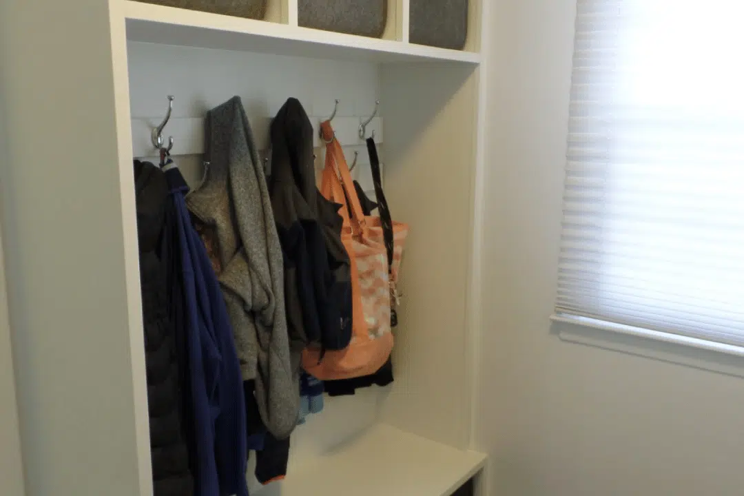 organized mudroom with labeled drawers