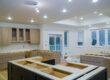 Cabinet maker installing kitchen cabinetry during a remodel