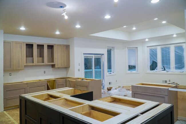 Unfinished kitchen cabinets and island frames during a kitchen remodel
