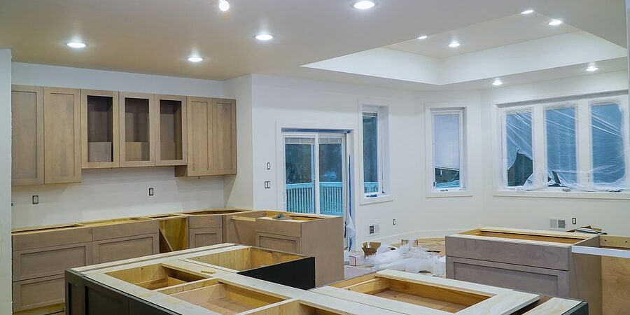 Unfinished kitchen cabinets and island frames during a kitchen remodel